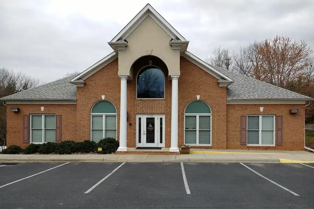 The brick Tega Cay City Hall with an arched window and white columns in South Carolina