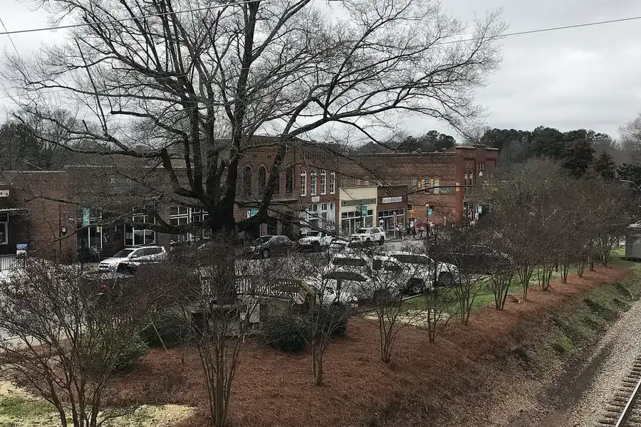 Bare winter trees and the railroad cut in front of downtown Waxhaw, North Carolina